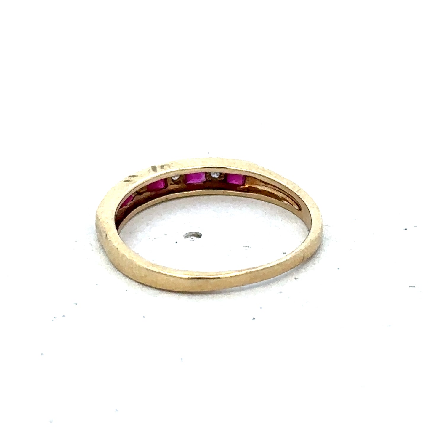 9ct yellow gold ruby and diamond ring, size K1/2, featuring a sparkling gemstone and intricate band design by Reeves and Sons.