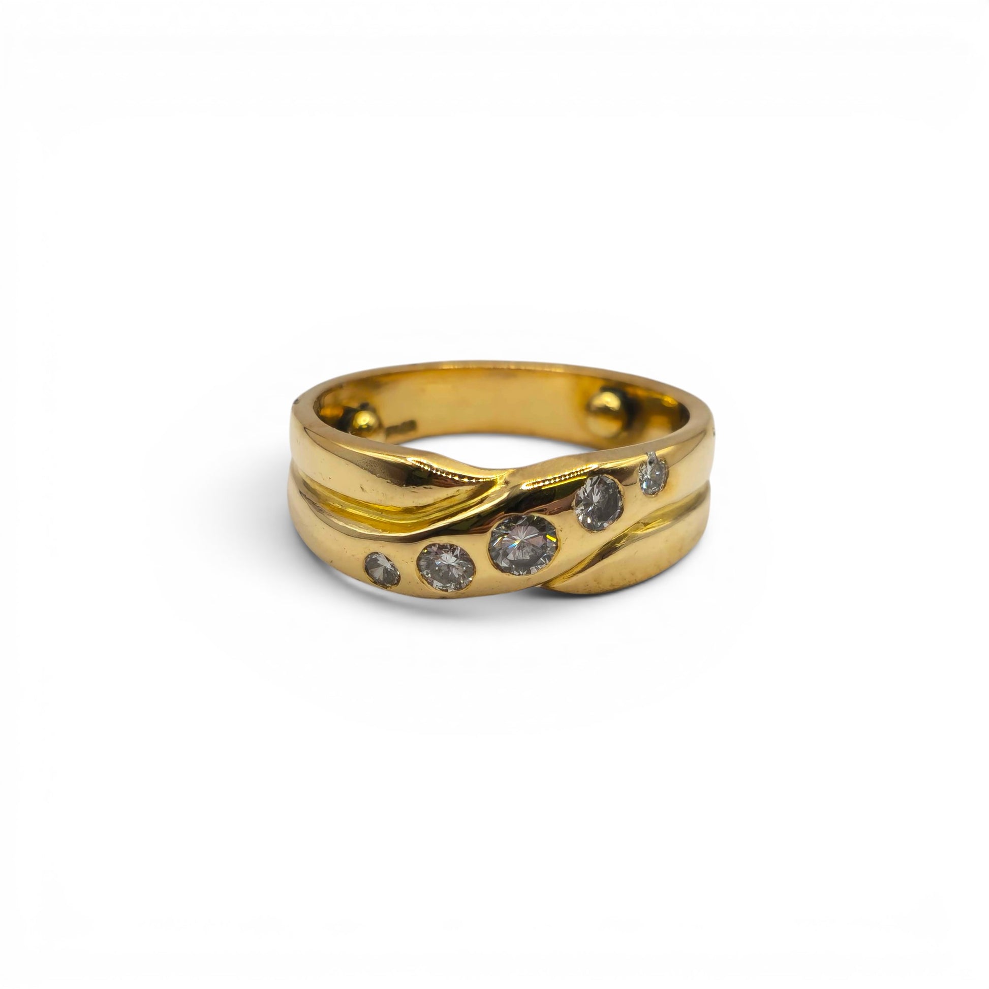18ct yellow gold diamond crossover ring by Reeves and Sons, showcasing a stylish design with sparkling diamonds on a sleek band.