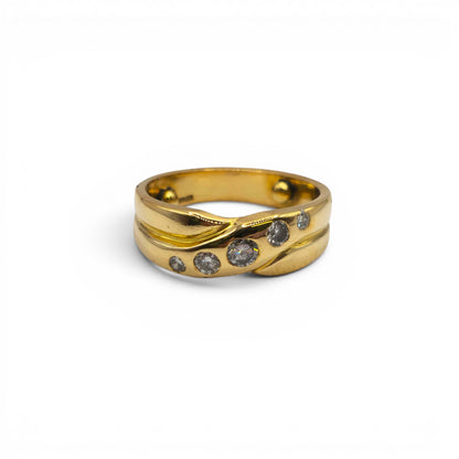 18ct yellow gold diamond crossover ring by Reeves and Sons, showcasing a stylish design with sparkling diamonds on a sleek band.