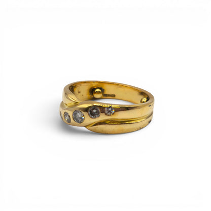 18ct yellow gold diamond crossover ring by Reeves and Sons featuring sparkling diamonds and a sleek, elegant design.