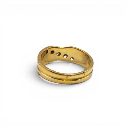 18ct yellow gold diamond crossover ring by Reeves and Sons, featuring sparkling diamonds and a sleek, elegant design.