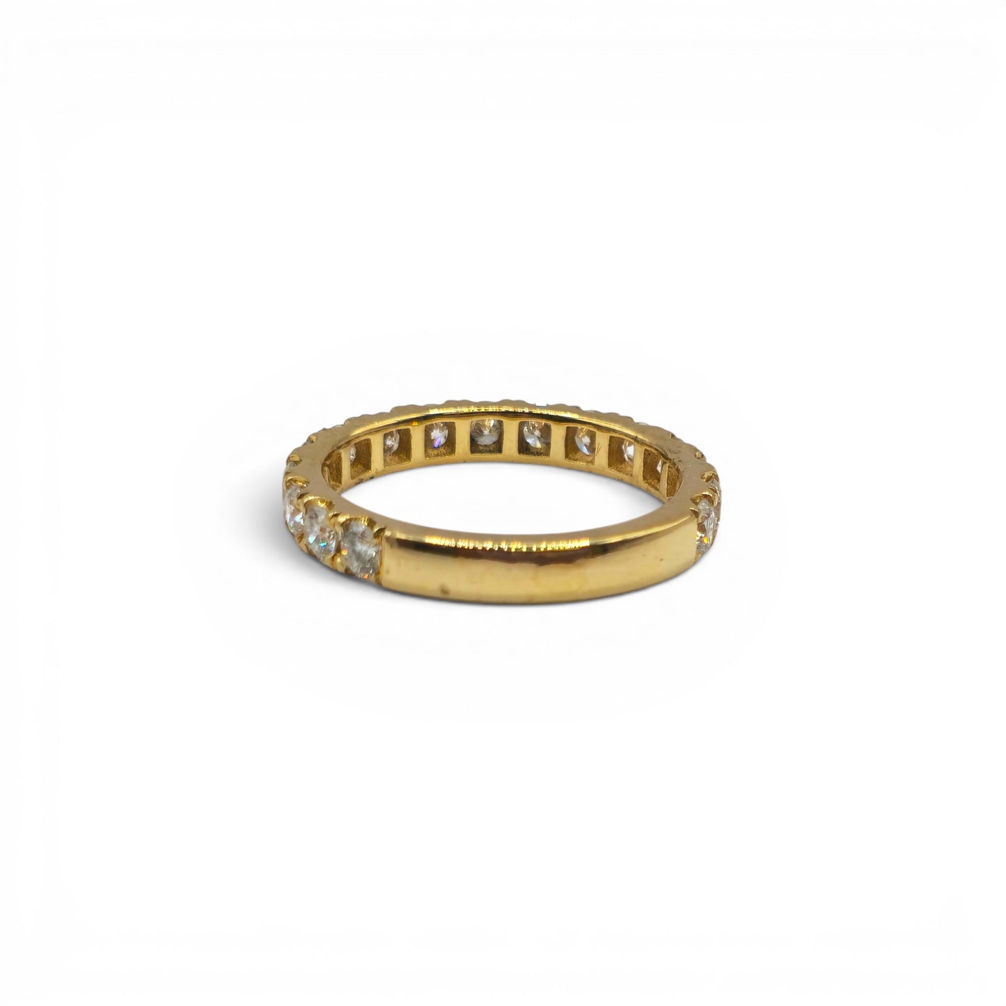 18ct yellow gold diamond eternity ring by Reeves and Sons featuring a continuous row of sparkling diamonds on a sleek band
