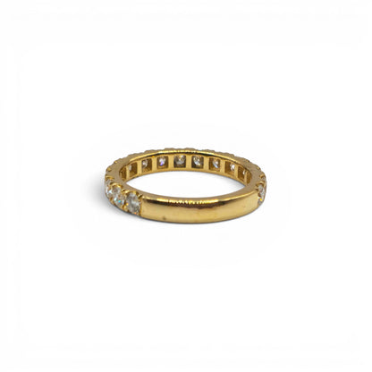 18ct yellow gold diamond eternity ring by Reeves and Sons featuring a continuous row of sparkling diamonds on a sleek band