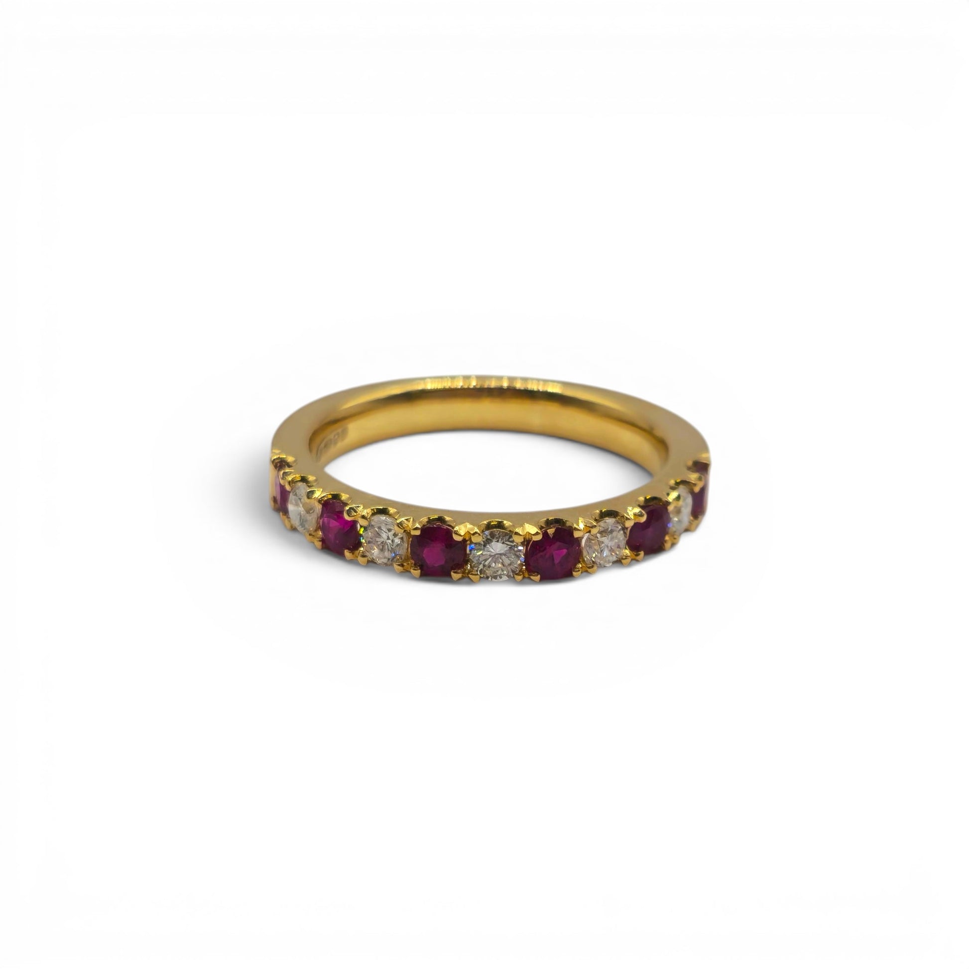18ct yellow gold ruby and diamond eternity ring by Reeves and Sons, featuring vibrant rubies and sparkling diamonds.