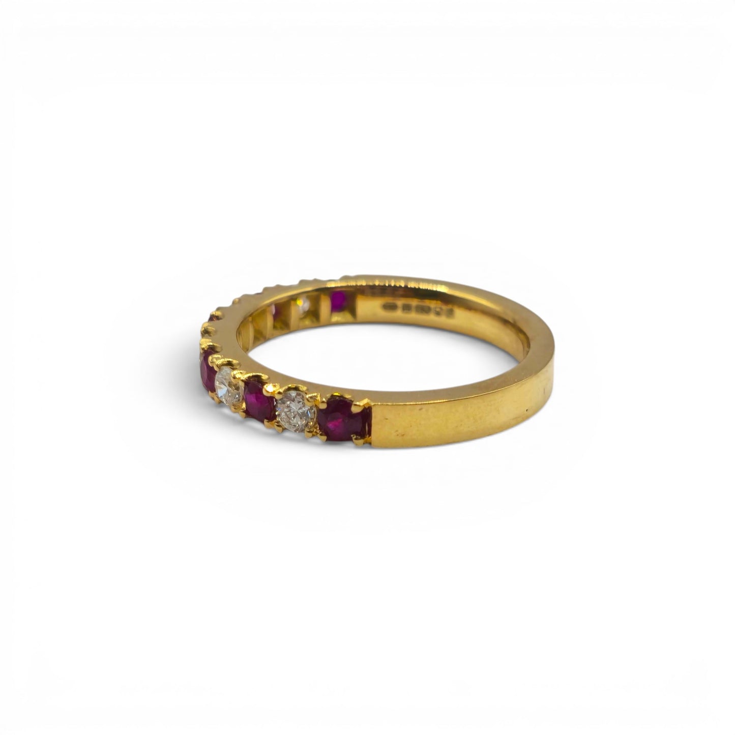 18ct yellow gold ruby and diamond eternity ring by Reeves and Sons, featuring a continuous row of sparkling gemstones.