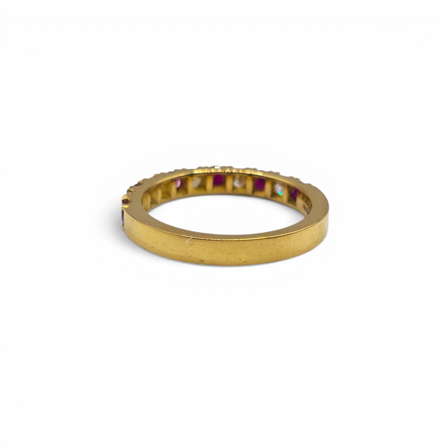 18ct yellow gold ruby and diamond eternity ring by Reeves and Sons, showcasing a band with vibrant rubies and sparkling diamonds.