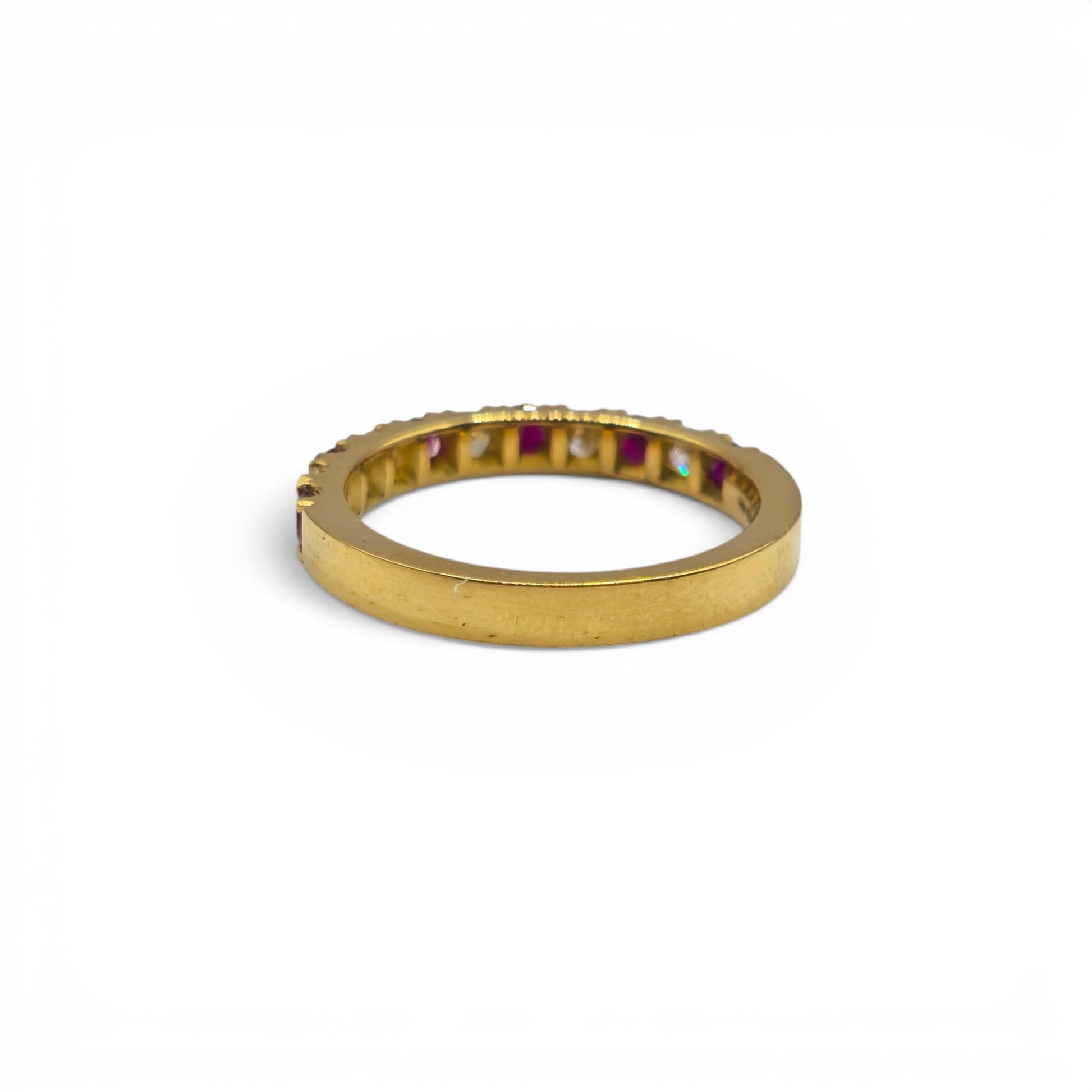 18ct yellow gold ruby and diamond eternity ring by Reeves and Sons, showcasing a band with vibrant rubies and sparkling diamonds.