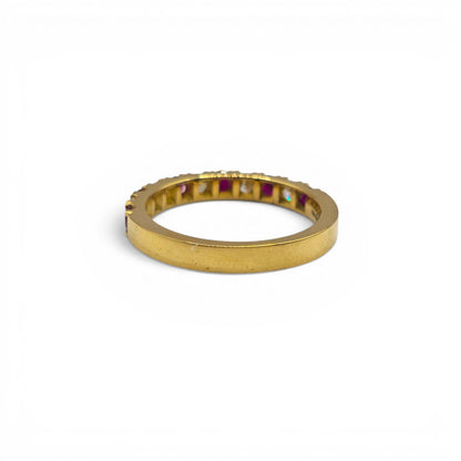 18ct yellow gold ruby and diamond eternity ring by Reeves and Sons, showcasing a band with vibrant rubies and sparkling diamonds.