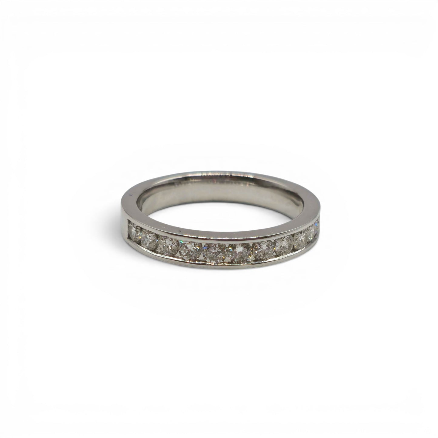 18ct white gold diamond half eternity ring with sparkling diamonds, featuring a sleek band design by Reeves and Sons.