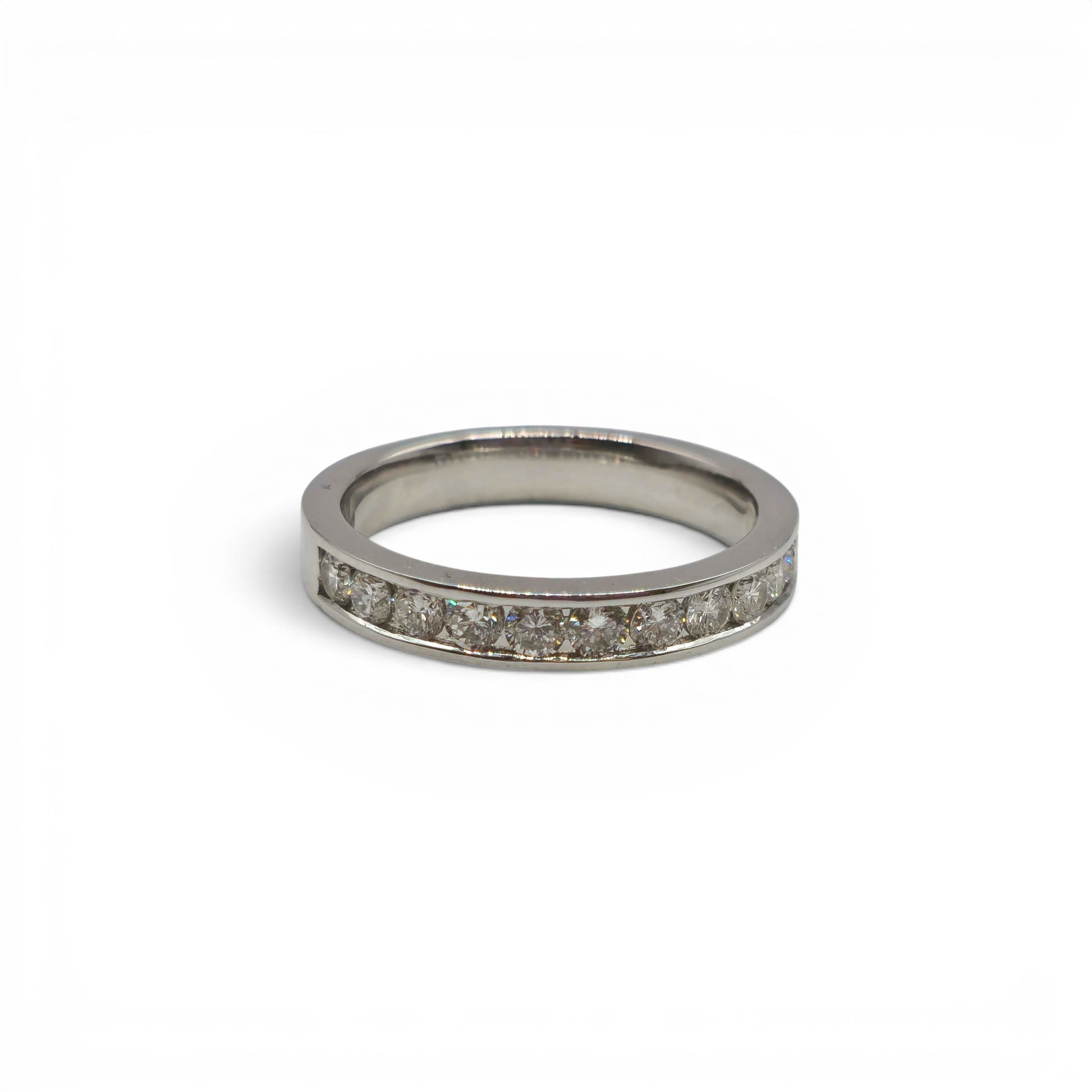 18ct white gold diamond half eternity ring with sparkling diamonds, featuring a sleek band design by Reeves and Sons.