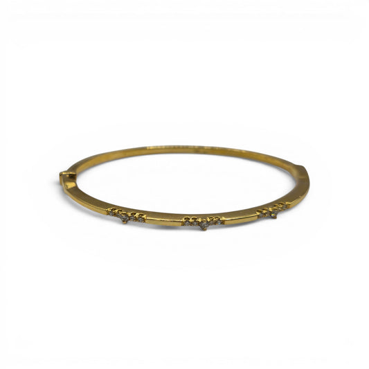 18ct yellow gold diamond bangle by Reeves and Sons, featuring sparkling diamonds set in a sleek, elegant design.