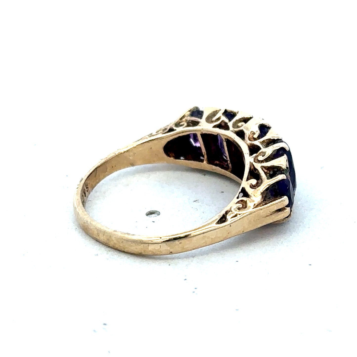9ct yellow gold amethyst ring with a large purple gemstone, size N, featuring intricate gold band design by Reeves and Sons
