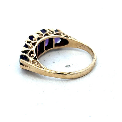 9ct yellow gold amethyst ring with a large purple gemstone, size N, featuring a detailed band by Reeves and Sons.