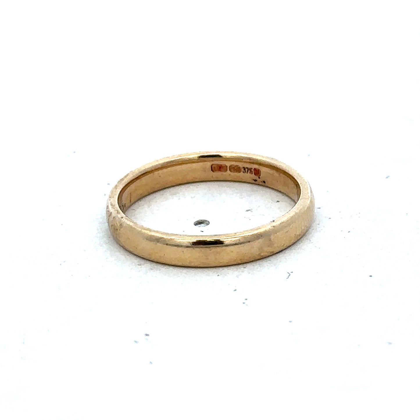 9ct yellow gold ring in size N featuring a smooth band design from Reeves and Sons.