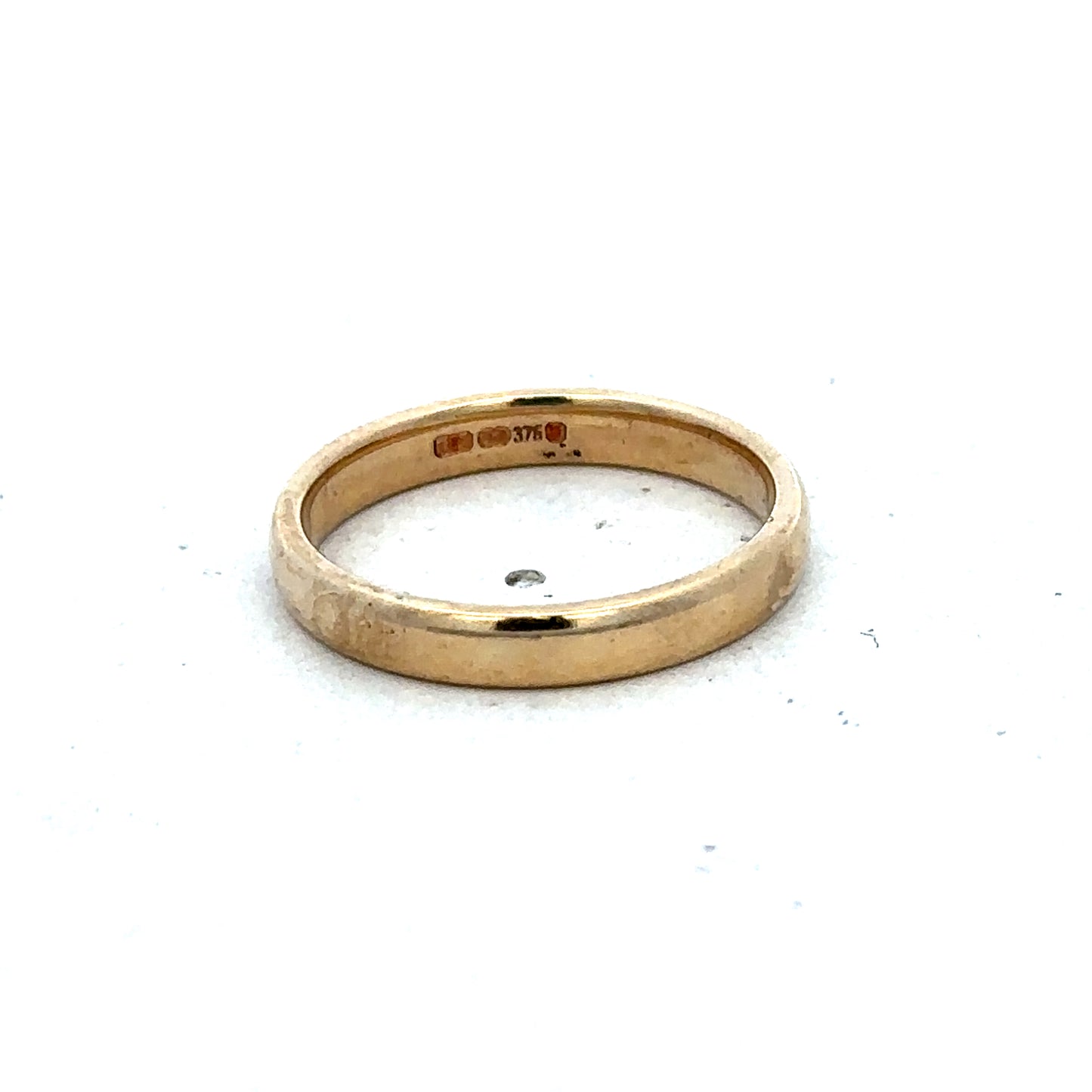 9ct yellow gold ring in size N by Reeves and Sons, featuring a smooth polished band and elegant design.
