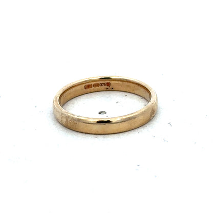 9ct yellow gold ring in size N by Reeves and Sons, featuring a smooth polished band and elegant design.