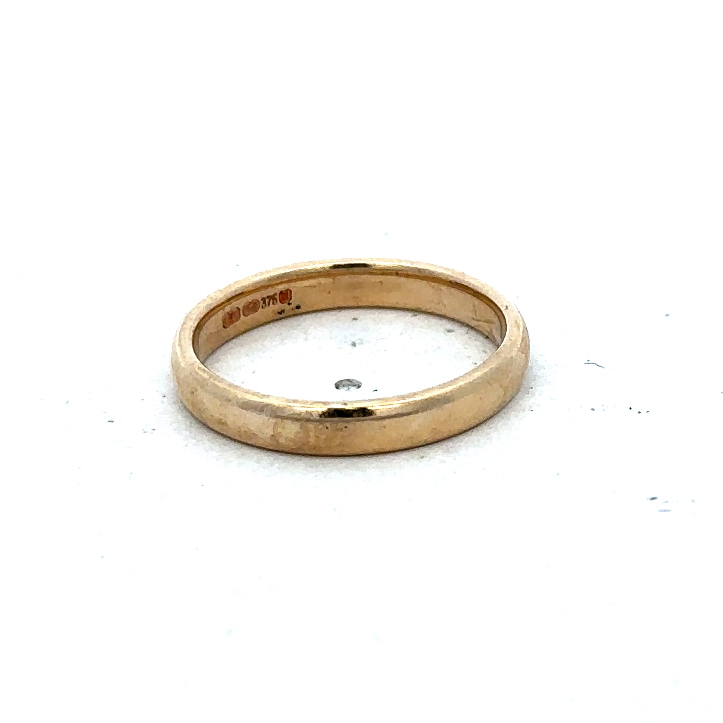 9ct yellow gold ring size N by Reeves and Sons, featuring a smooth polished band with a classic design.