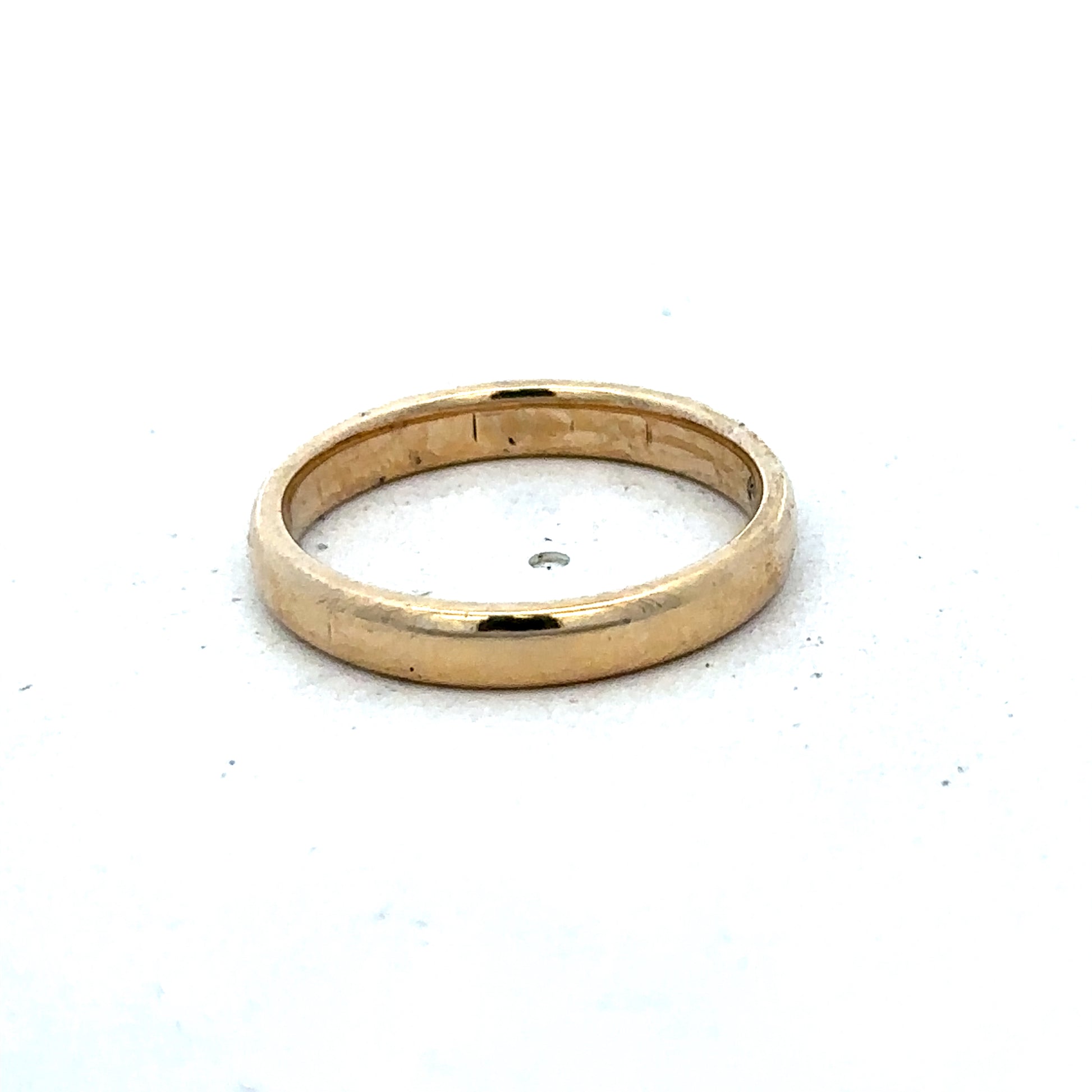9ct yellow gold ring in size N by Reeves and Sons, showcasing a smooth polished band with subtle detailing.