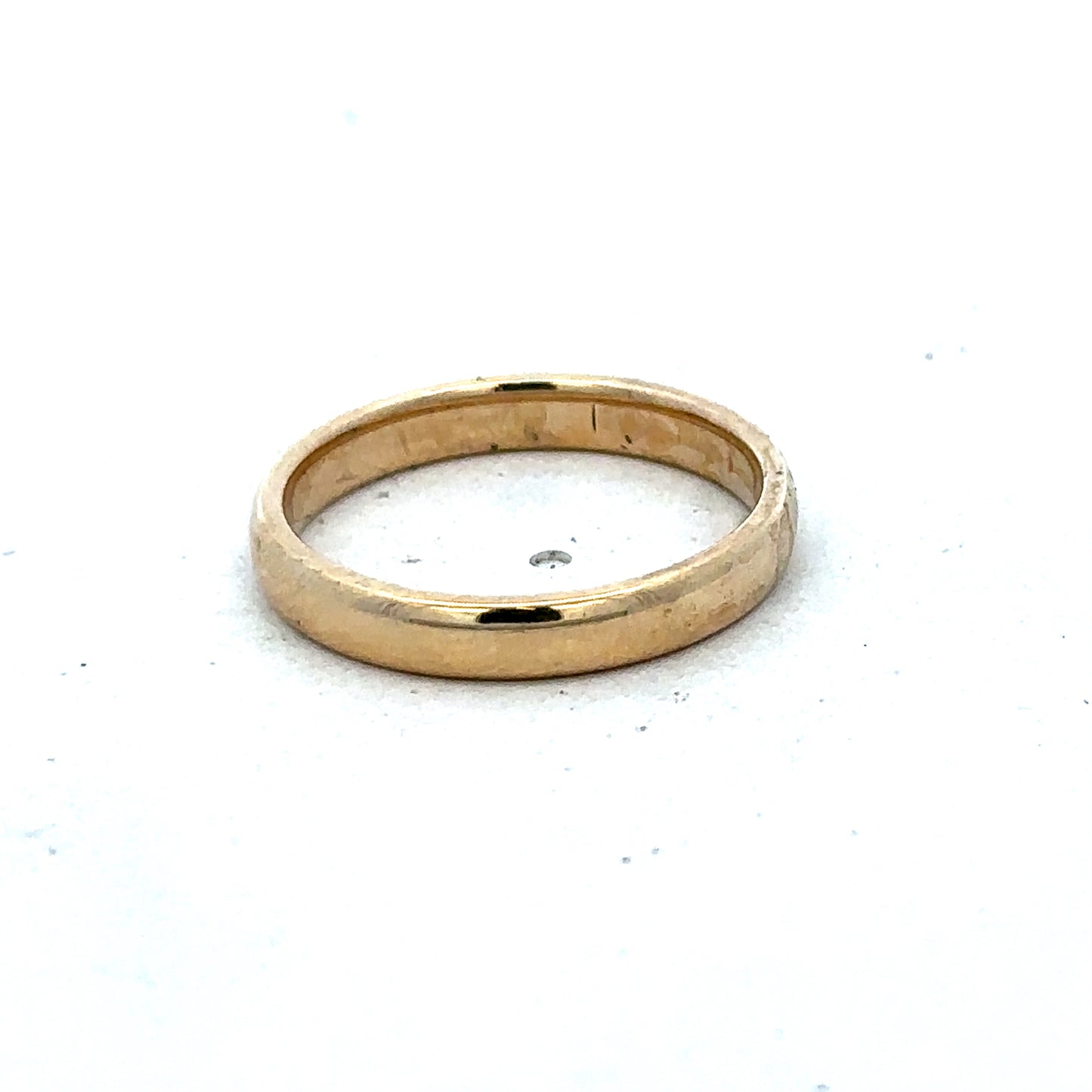 Gold ring in size N by Reeves and Sons, crafted in 9ct yellow gold with a simple, elegant band design.