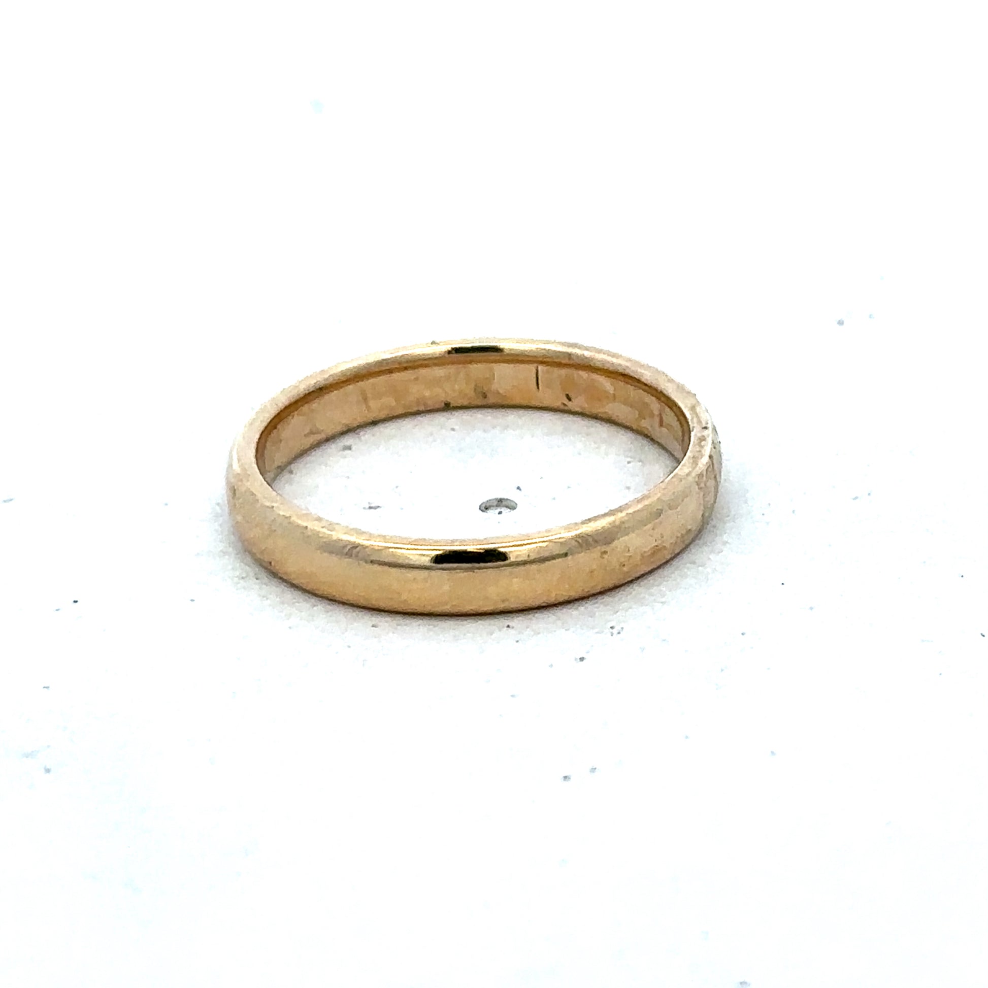 Gold ring in size N by Reeves and Sons, crafted in 9ct yellow gold with a simple, elegant band design.