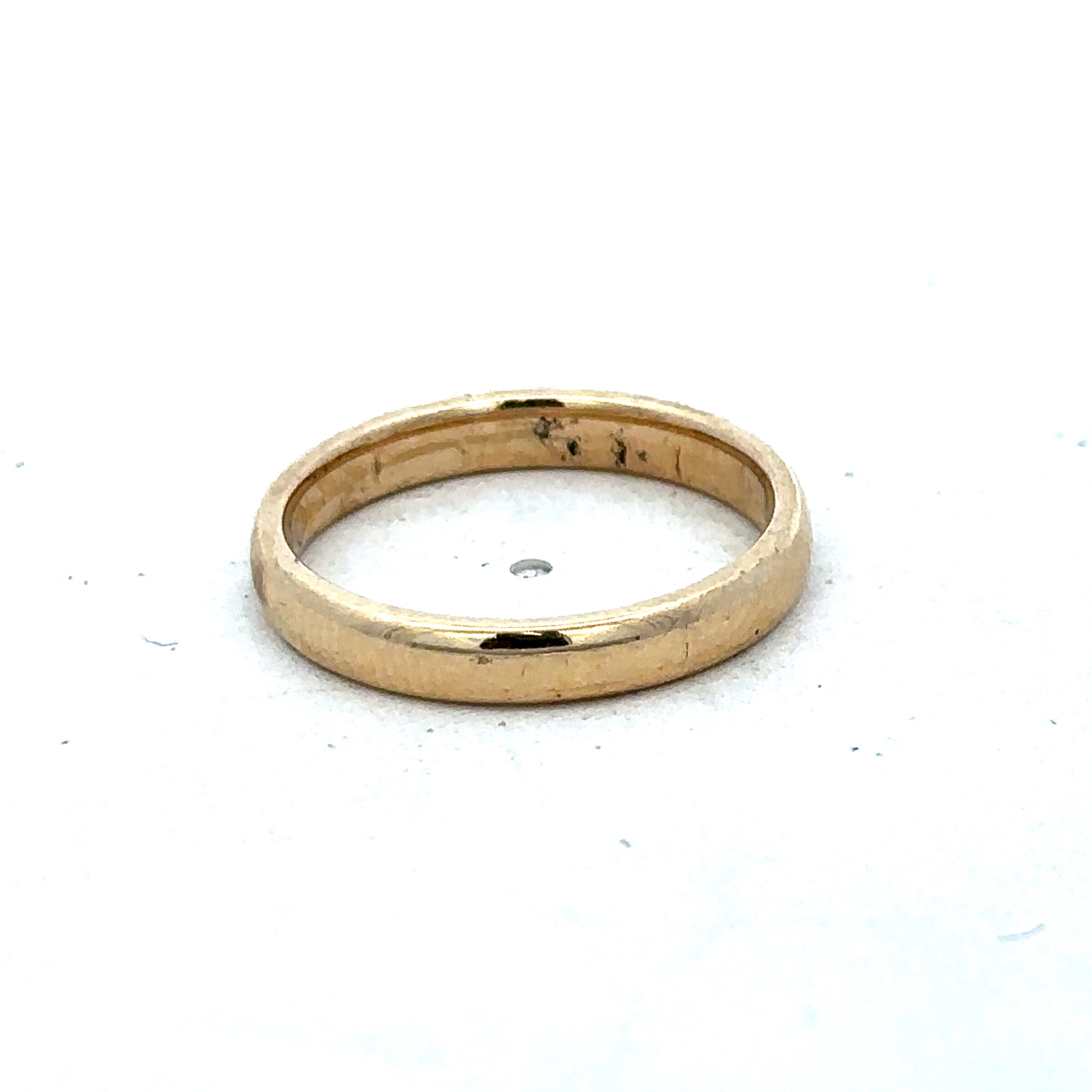 9ct yellow gold ring in size N by Reeves and Sons, featuring a polished band with subtle design details.