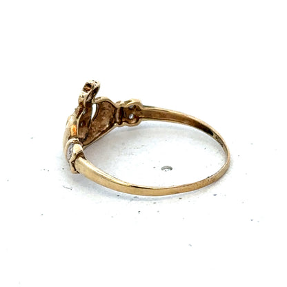 9ct yellow gold Claddagh ring in size V with detailed heart and crown design, crafted by Reeves and Sons.
