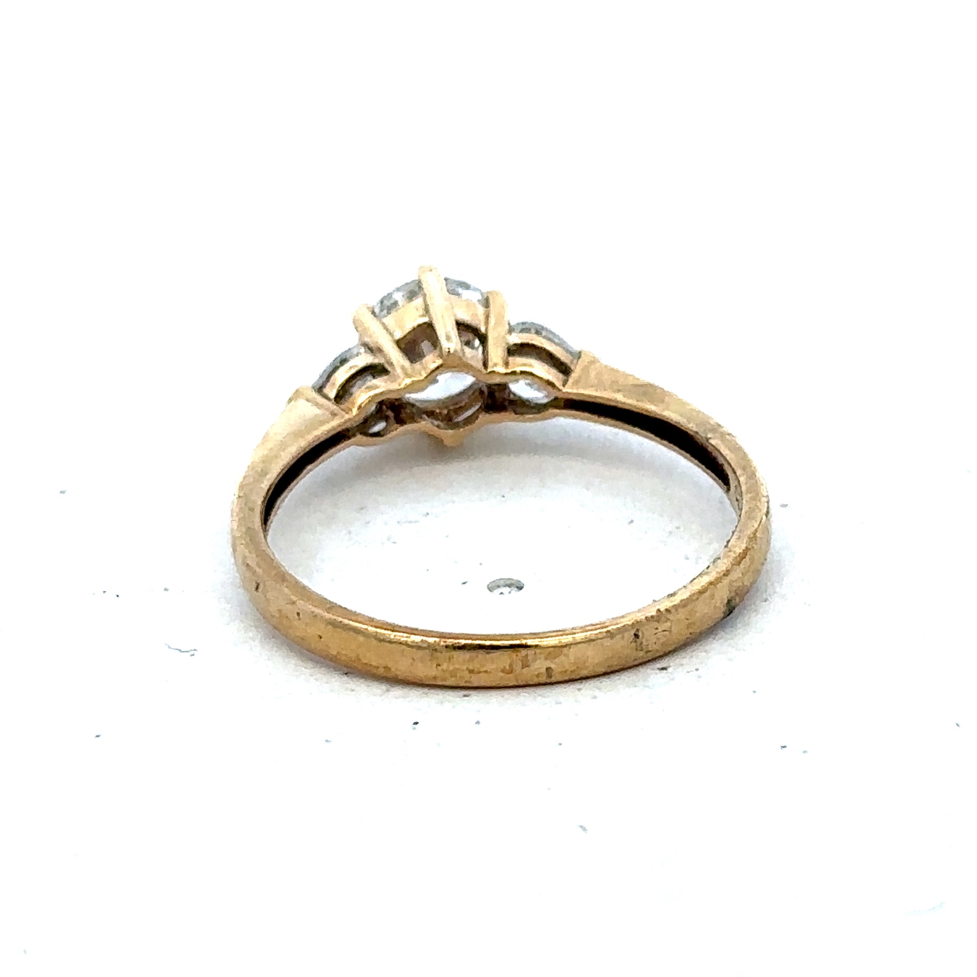 9ct yellow gold CZ ring in size U featuring a sparkling central stone, crafted by Reeves and Sons.