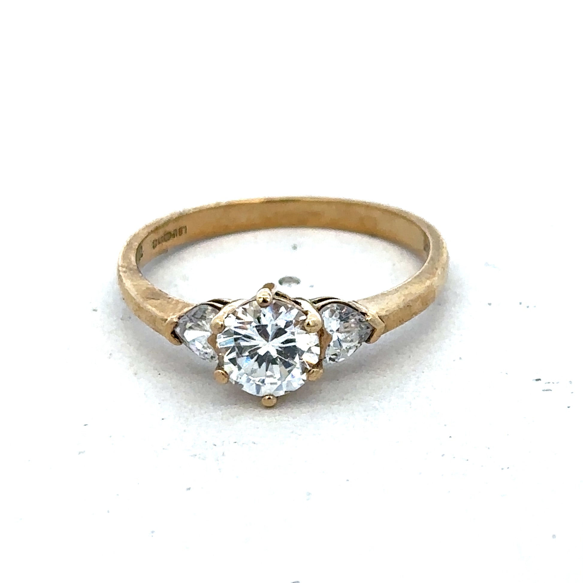 9ct yellow gold CZ ring size U by Reeves and Sons, featuring a sparkling cubic zirconia gemstone in a classic band design.