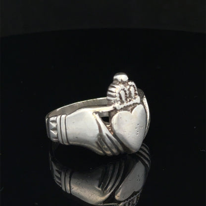 Silver Claddagh ring in size Z1 by Reeves and Sons, featuring detailed craftsmanship and symbolic heart and hands design.