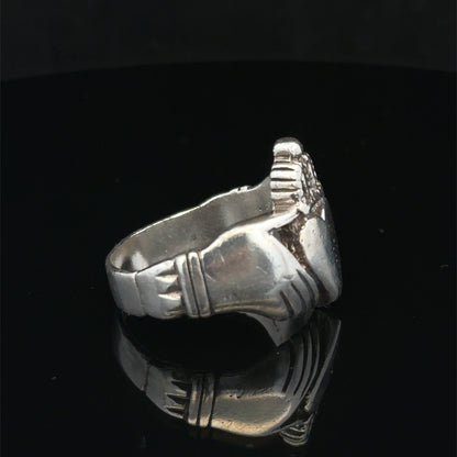 Silver Claddagh ring size Z1 by Reeves and Sons, featuring intricate heart and crown design, displayed on a neutral background.