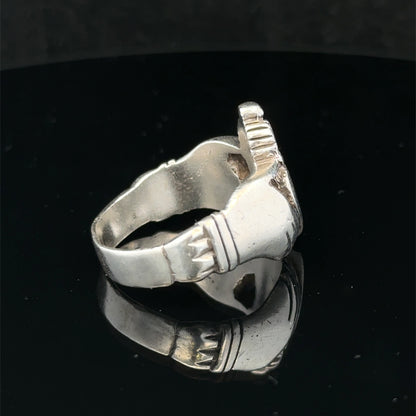 Silver Claddagh ring in size Z1 by Reeves and Sons, featuring a detailed heart and crown design, resting on a neutral background.