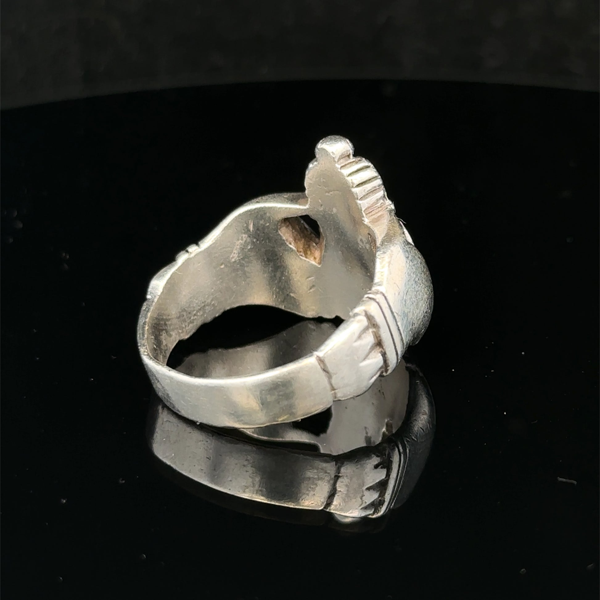 Silver Claddagh ring size Z1 by Reeves and Sons, featuring traditional design with heart, hands, and crown symbols.