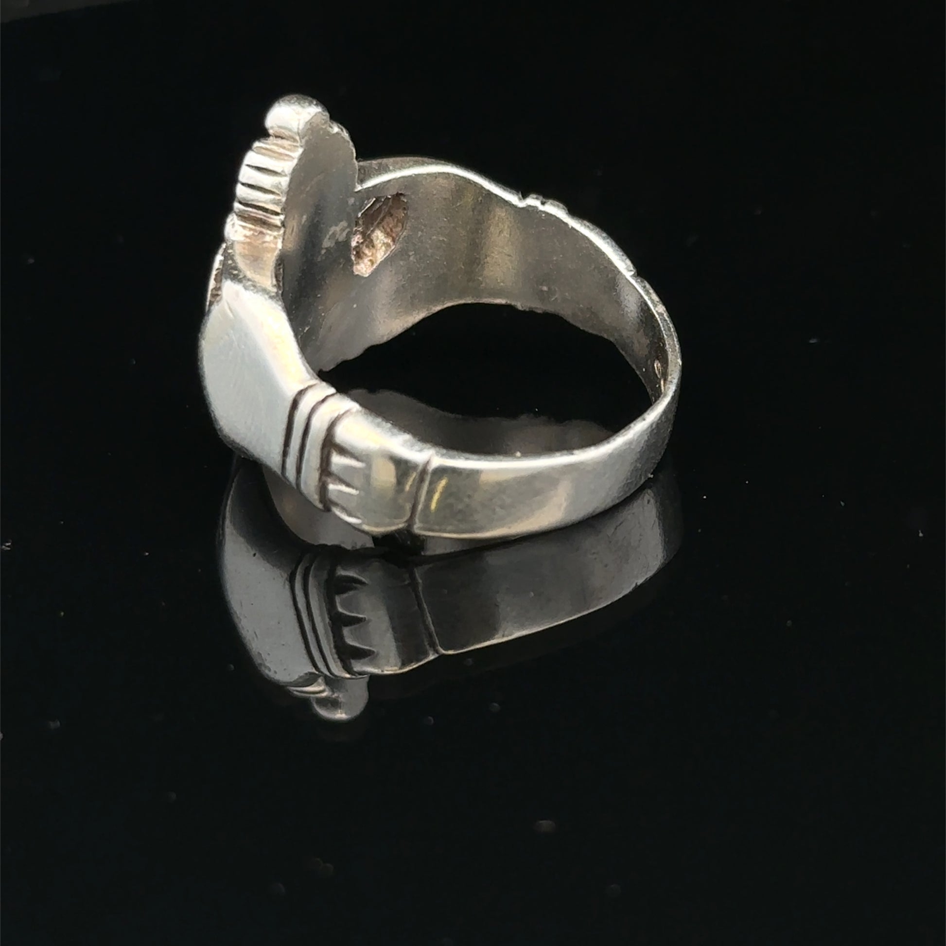 Silver Claddagh ring size Z1 by Reeves and Sons, featuring a detailed heart and hands design, displayed on a white background.