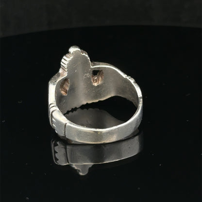 Silver Claddagh ring size Z1 by Reeves and Sons featuring a detailed heart and hands design on a polished band.