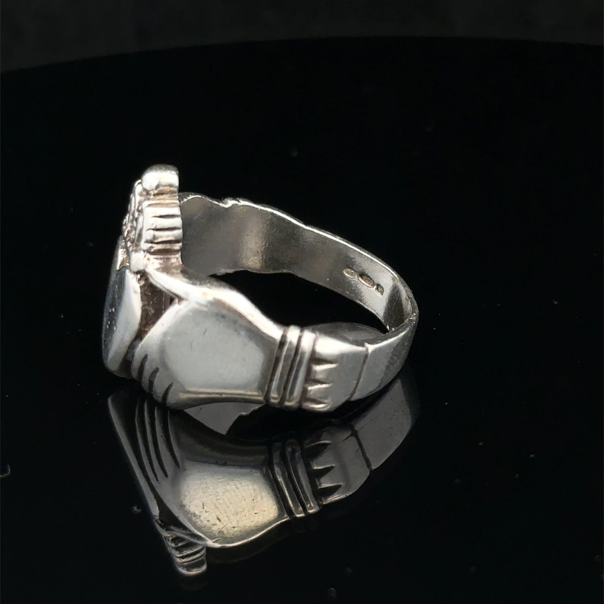 Silver Claddagh ring size Z1 by Reeves and Sons, featuring a detailed heart and crown design, close-up view.