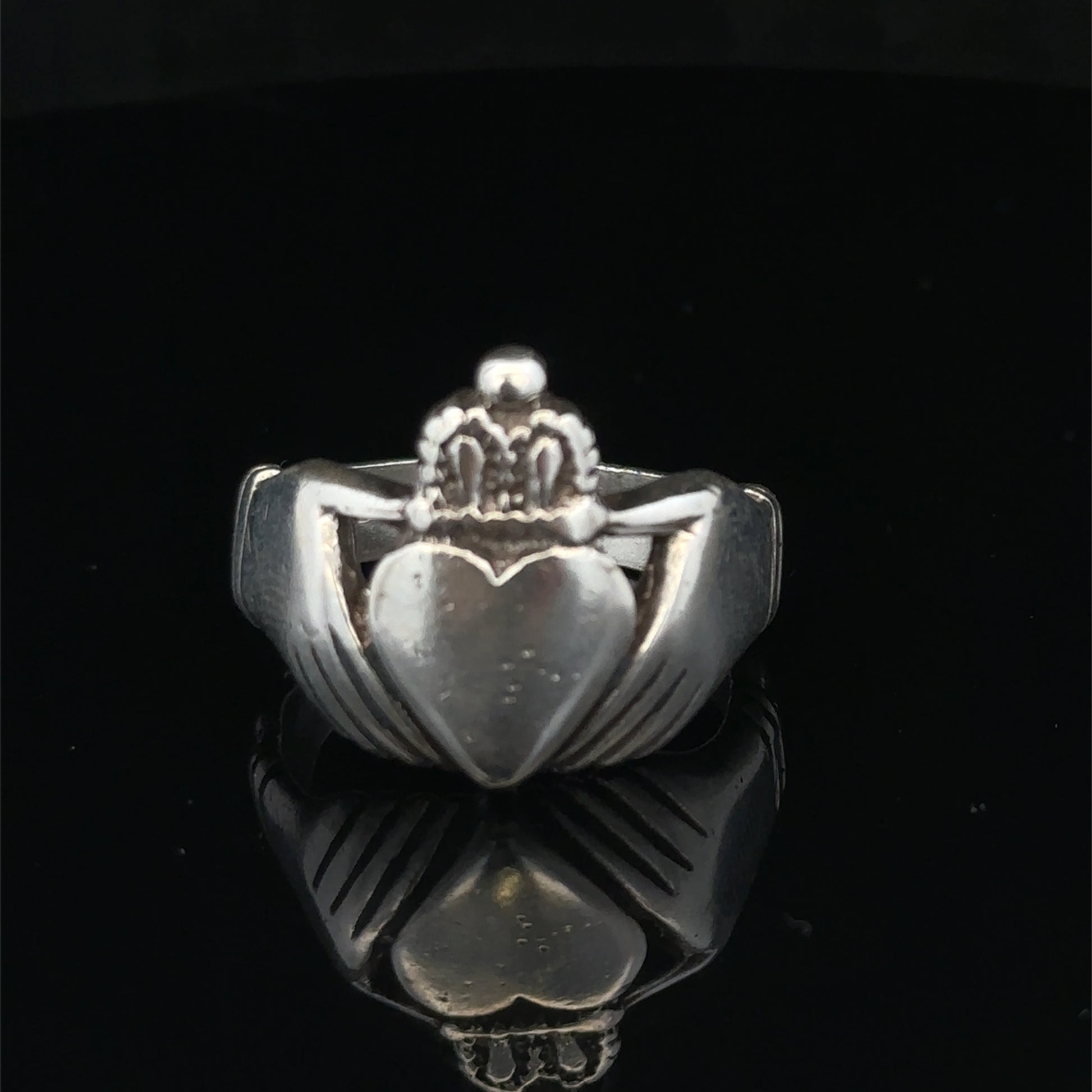 Silver Claddagh ring in size Z1 by Reeves and Sons, featuring traditional heart and crown design, displayed against a neutral background.