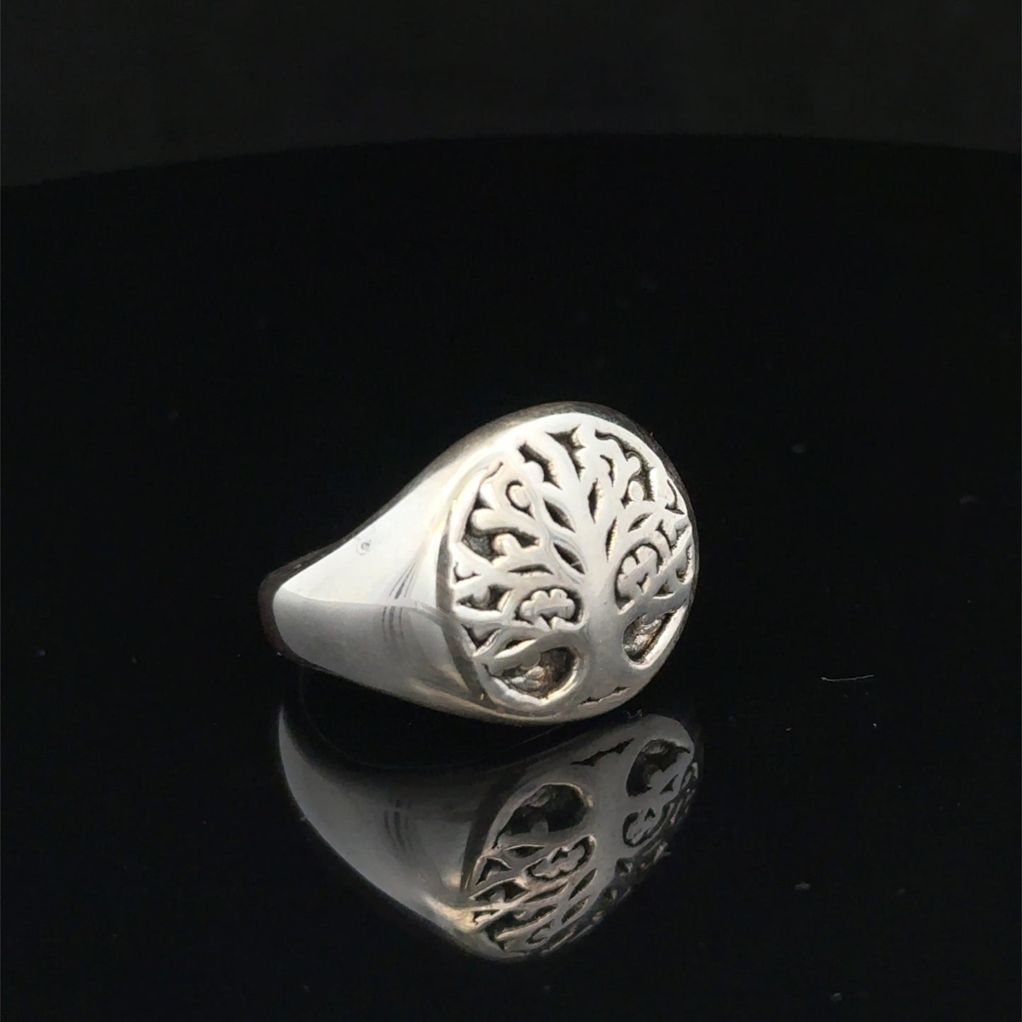 Silver ring size P by Reeves and Sons, showcasing a smooth band with a polished finish on a plain background.