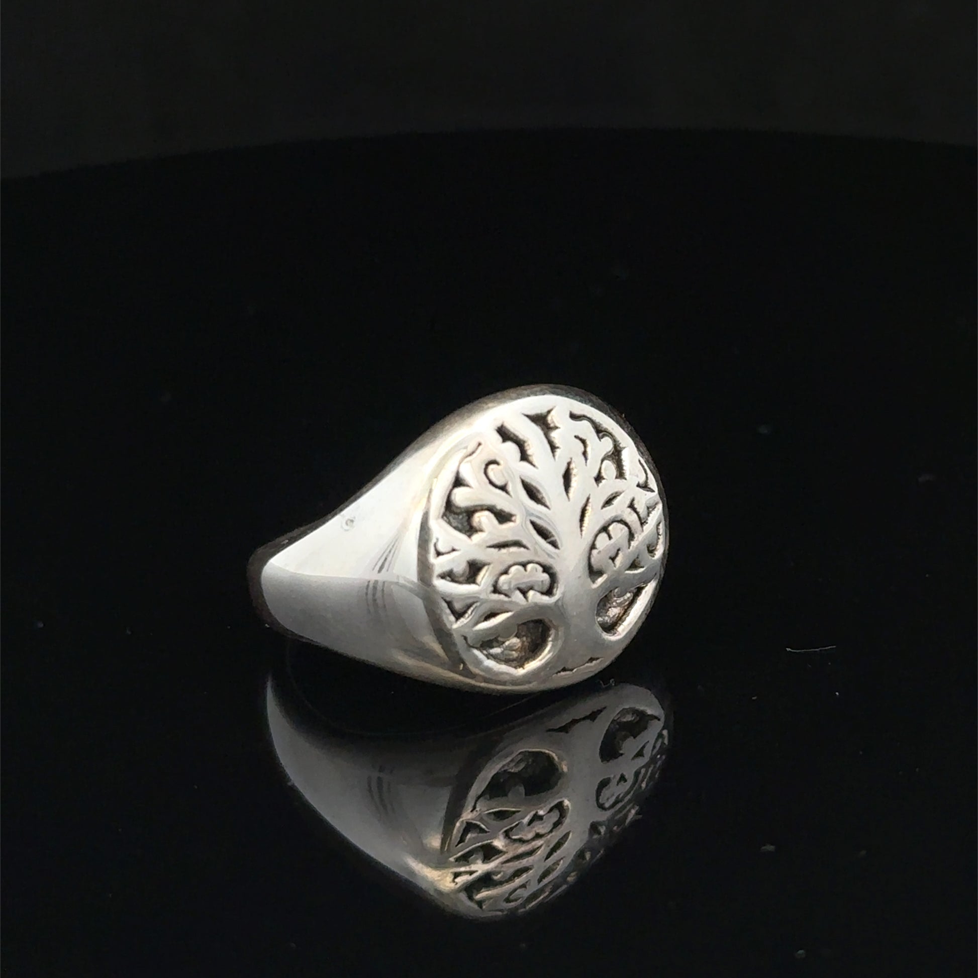 Silver ring size P by Reeves and Sons, showcasing a smooth band with a polished finish on a plain background.