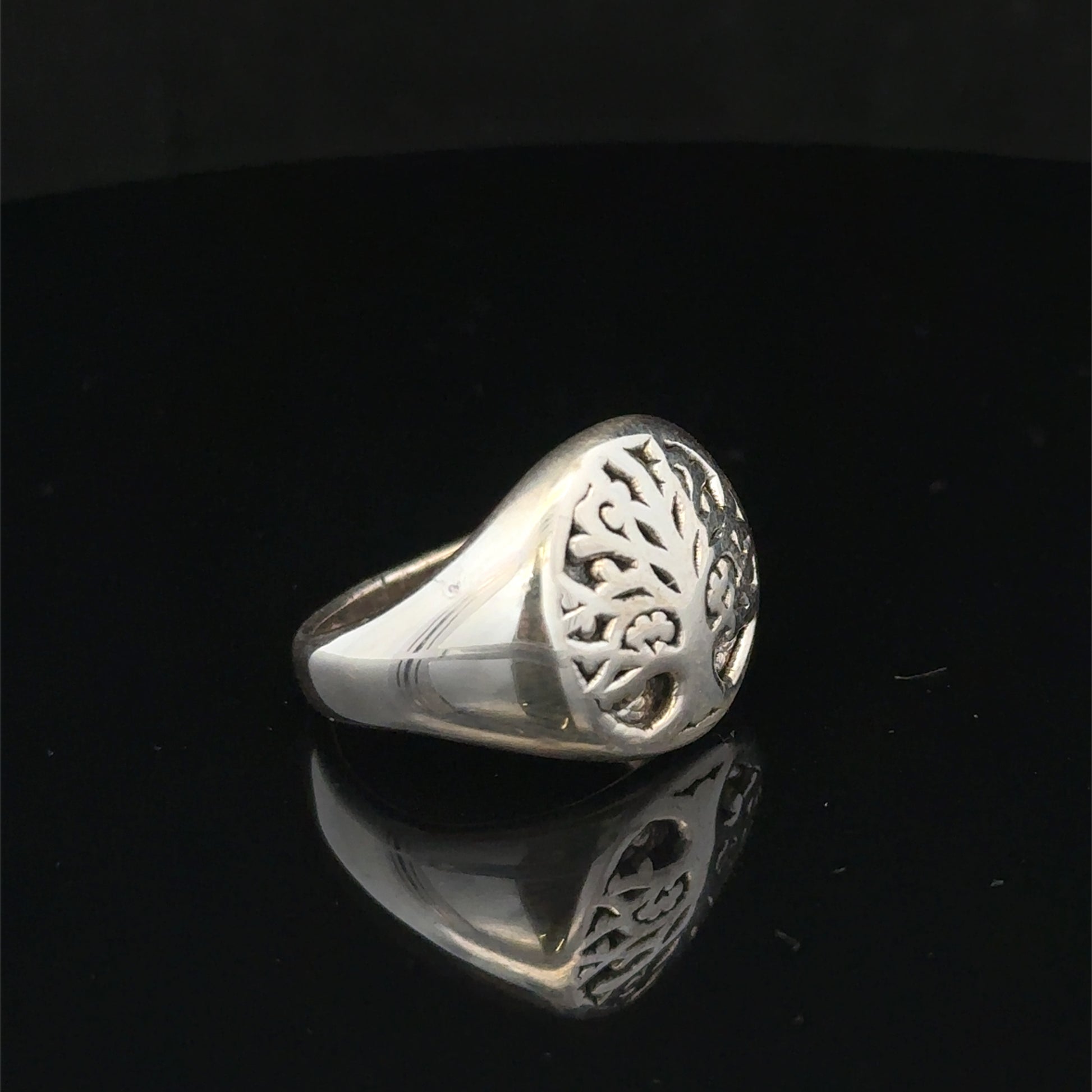 Silver ring size P from Reeves and Sons, featuring a polished band with subtle design details visible on the surface.