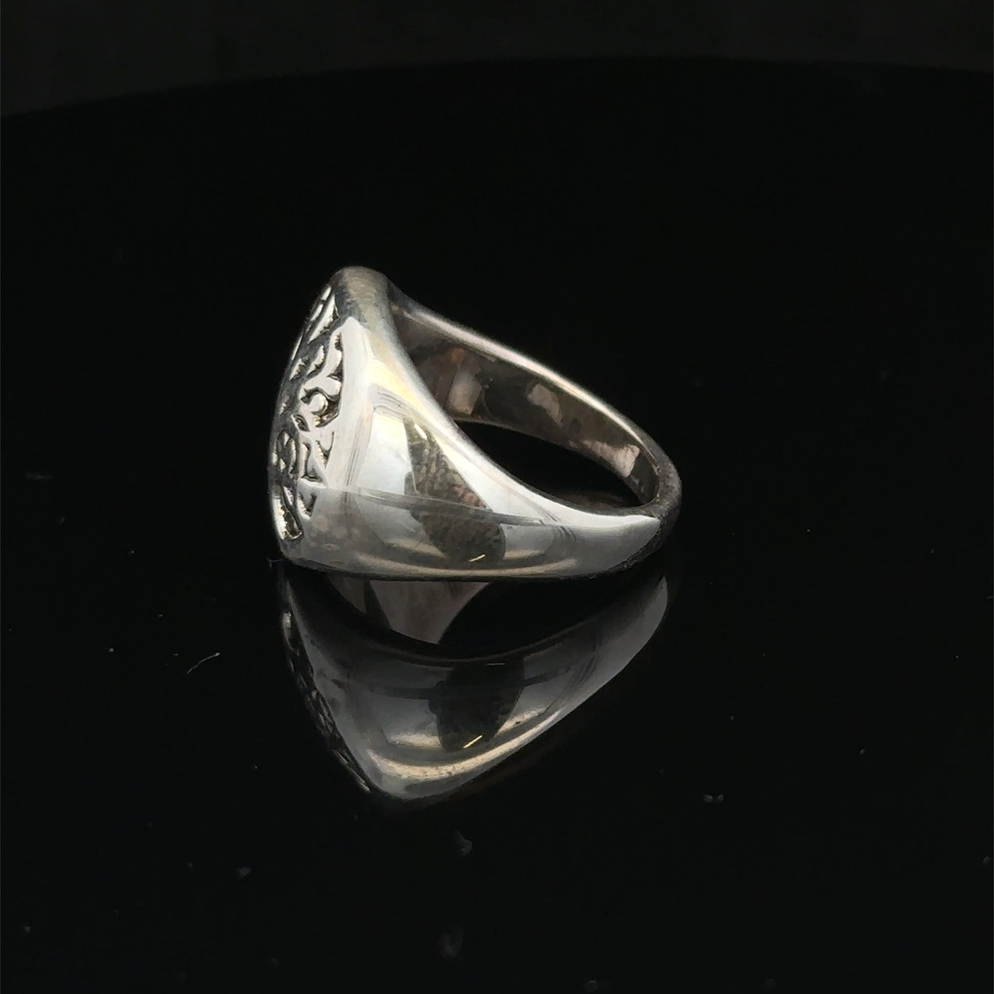 Silver ring size P by Reeves and Sons showcasing a polished band with a smooth, shiny finish.
