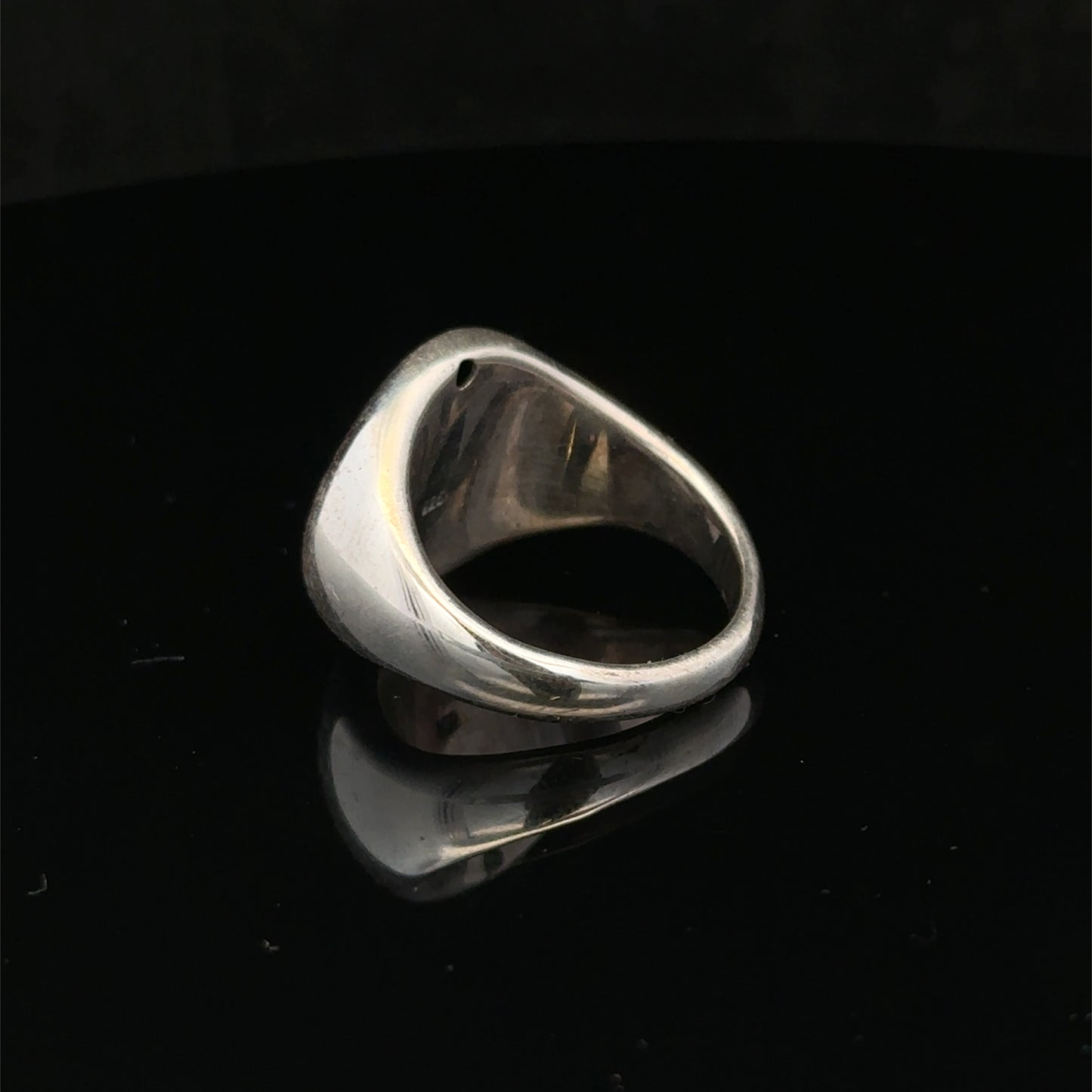 Silver ring size P by Reeves and Sons, featuring a polished band with intricate design details.