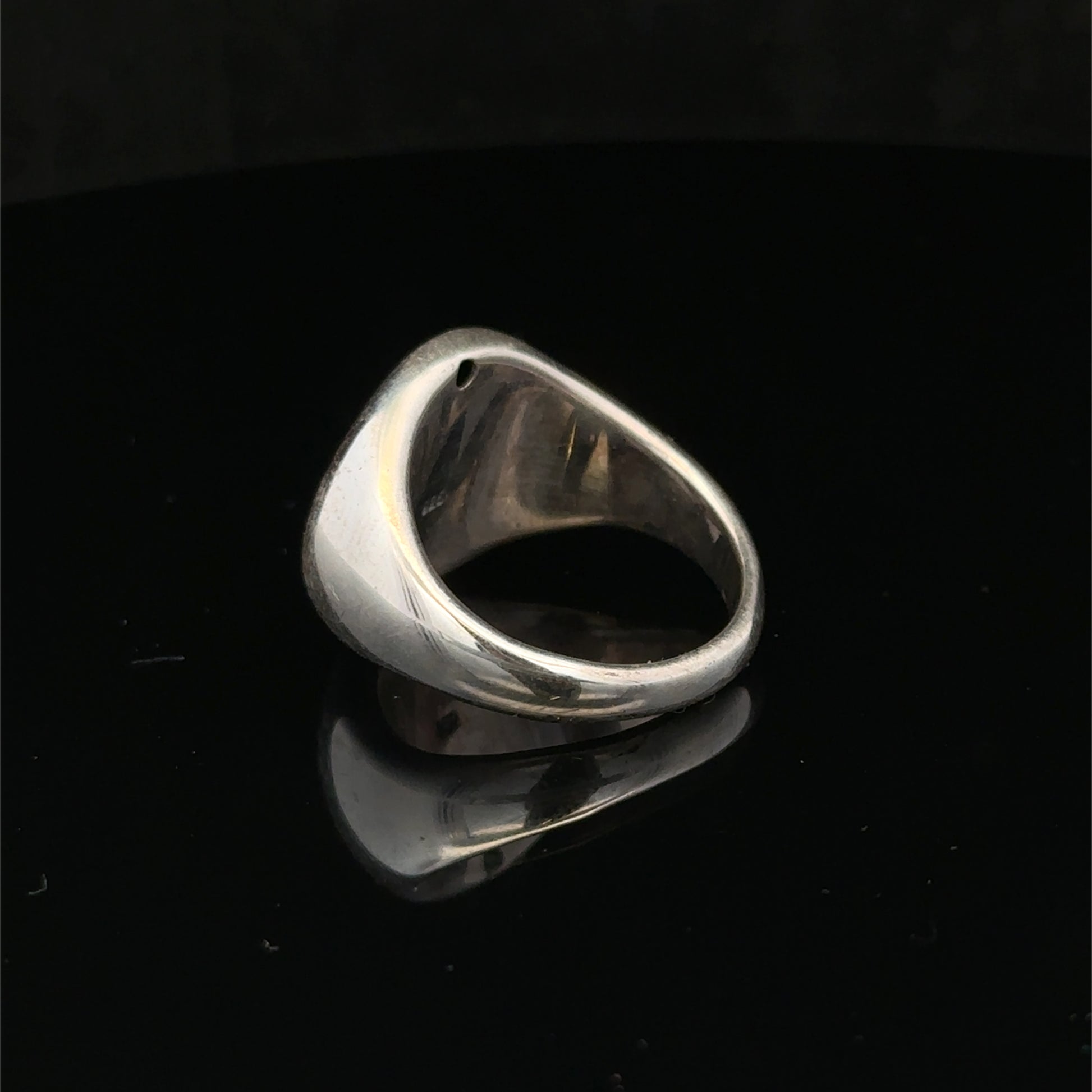 Silver ring size P by Reeves and Sons, featuring a polished band with intricate design details.