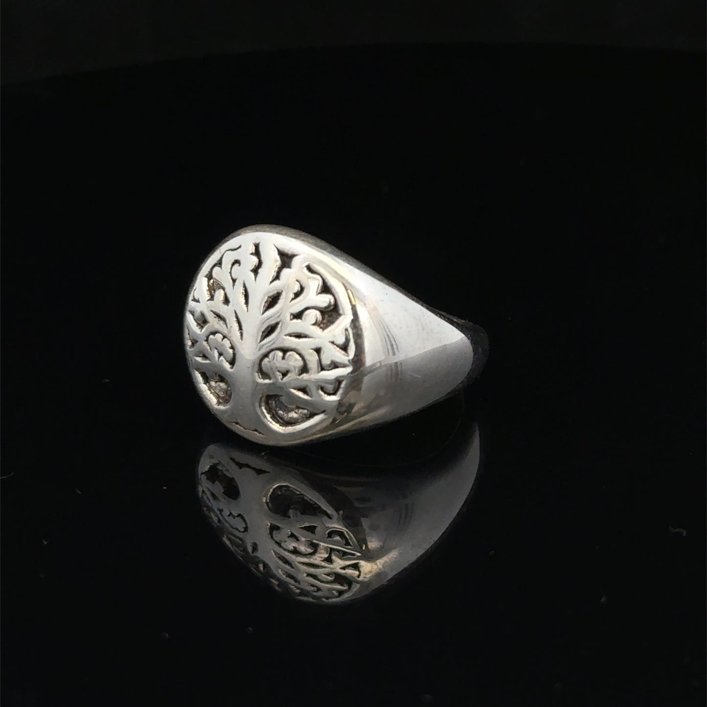 Silver ring size P by Reeves and Sons, showing the detailed band design and shiny finish.