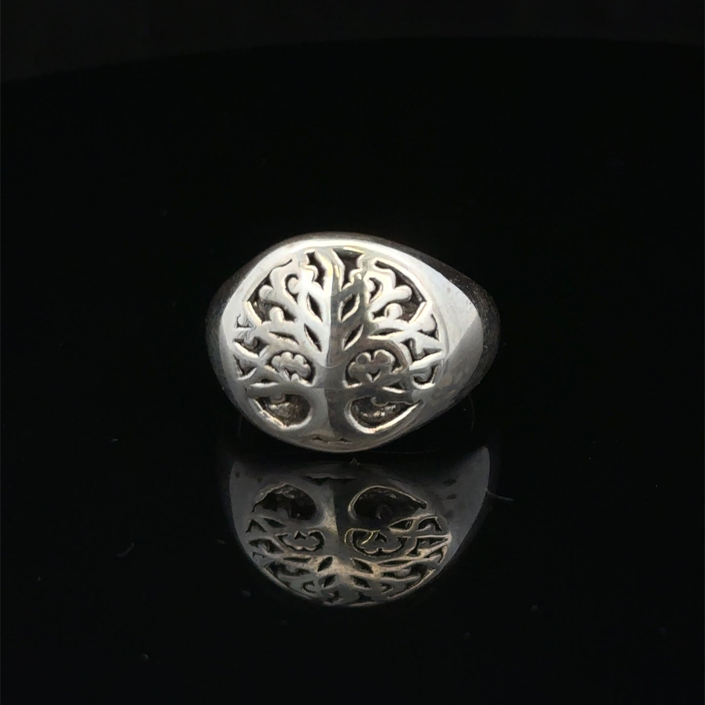 Silver ring size P by Reeves and Sons, featuring a smooth band design, displayed on a neutral background.