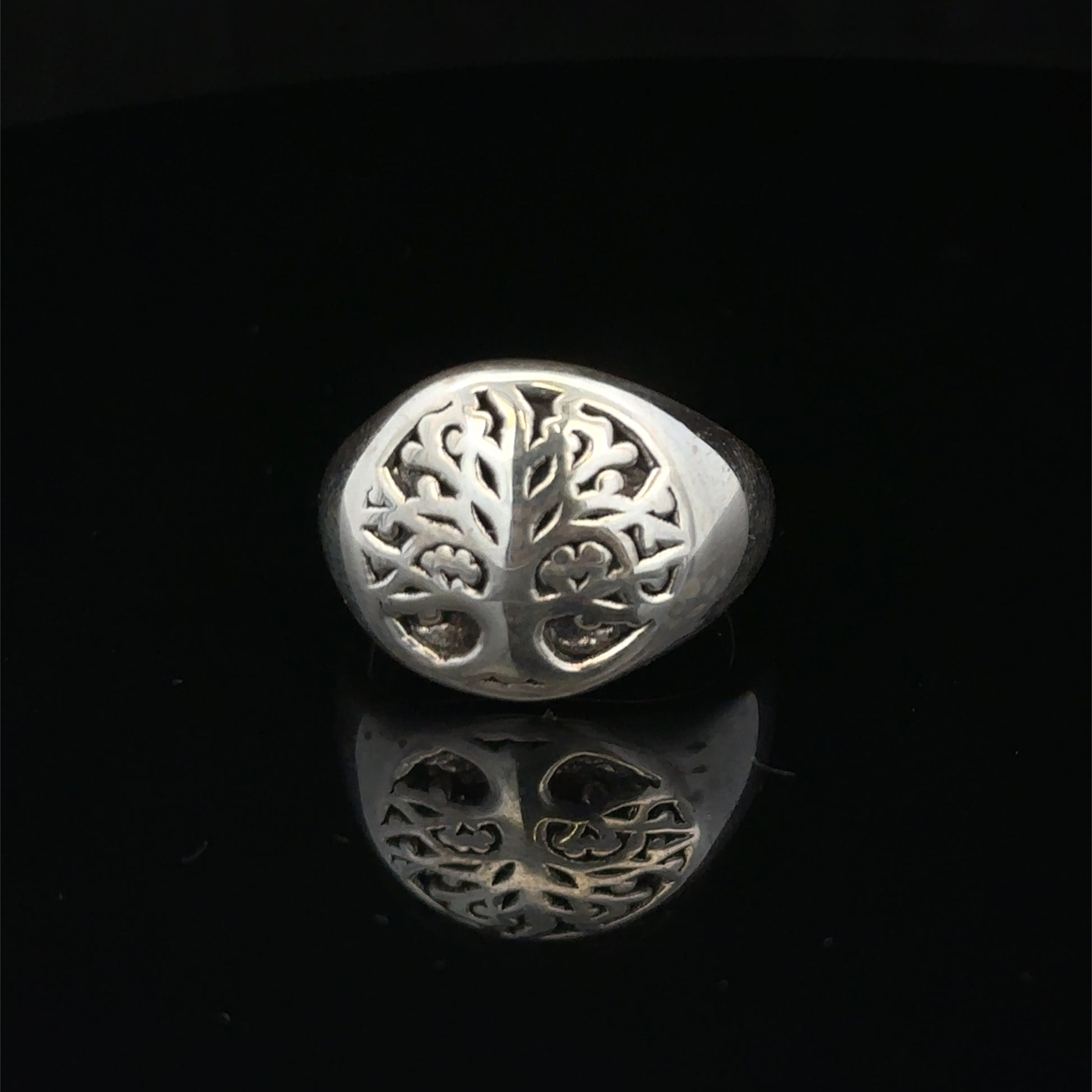 Silver ring size P by Reeves and Sons, featuring a smooth band design, displayed on a neutral background.
