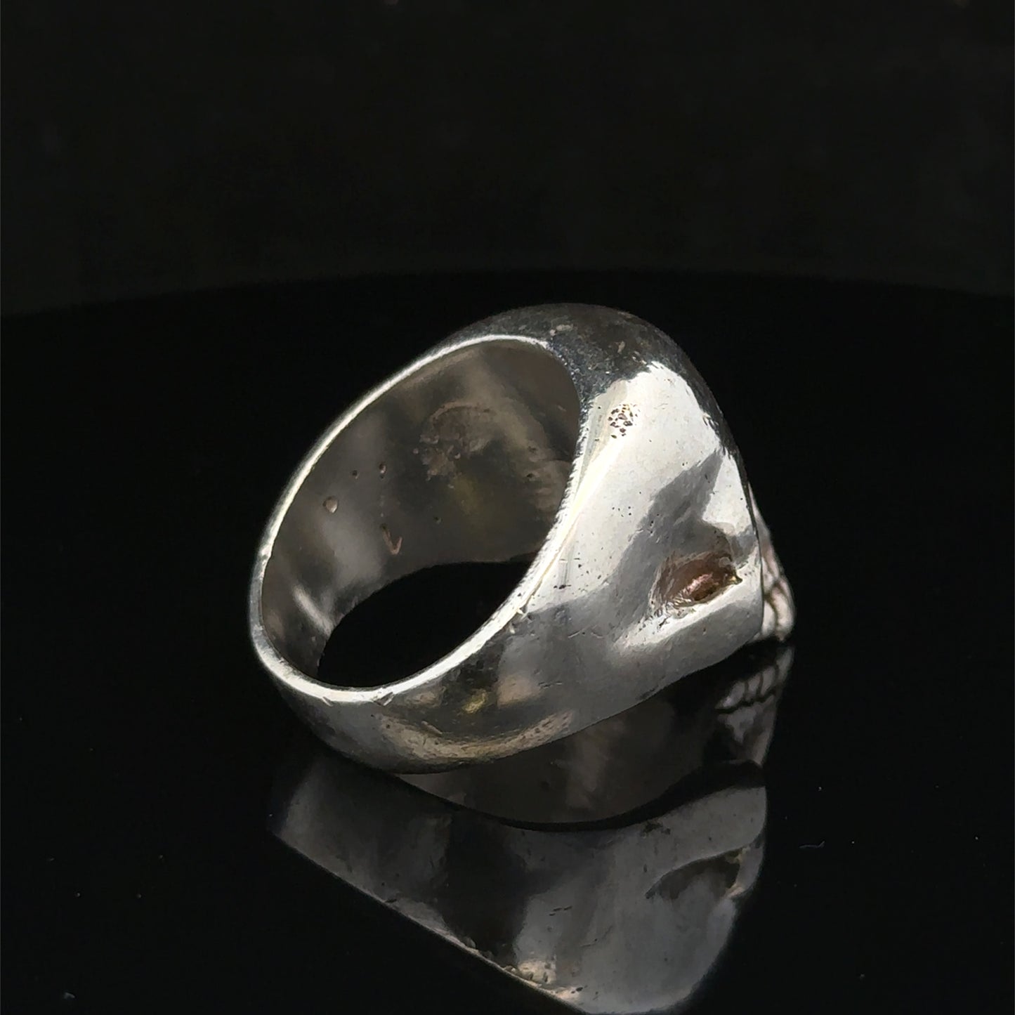 Silver skull ring by Reeves and Sons, size Z1, featuring detailed skull design, polished finish, and stylish jewelry craftsmanship.