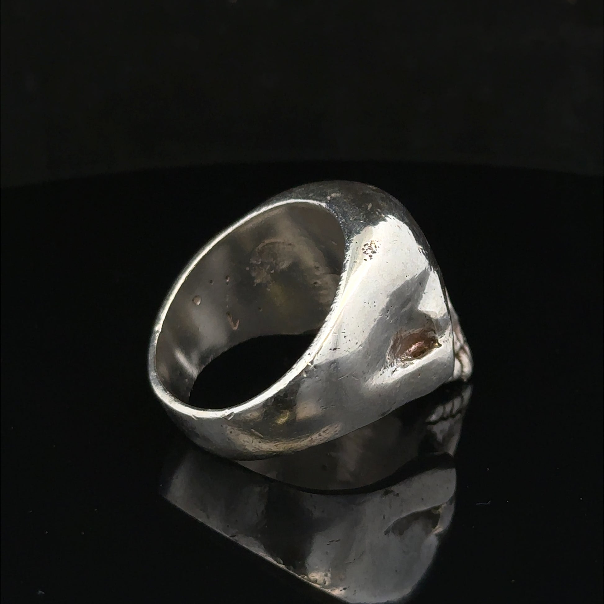 Silver skull ring by Reeves and Sons, size Z1, featuring detailed skull design, polished finish, and stylish jewelry craftsmanship.
