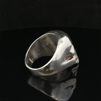 Silver skull ring by Reeves and Sons, size Z1, featuring detailed skull design, polished finish, and stylish jewelry craftsmanship.