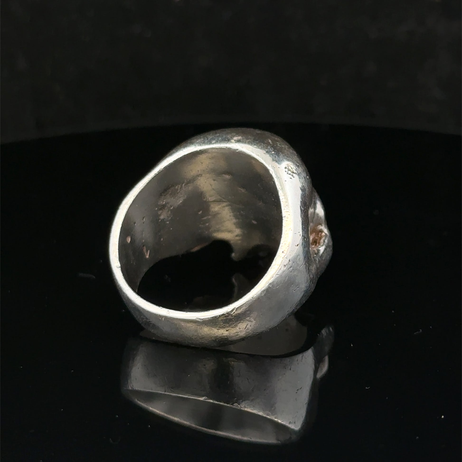 Silver skull ring by Reeves and Sons, size Z1, featuring detailed skull design, polished finish, and stylish jewelry craftsmanship.