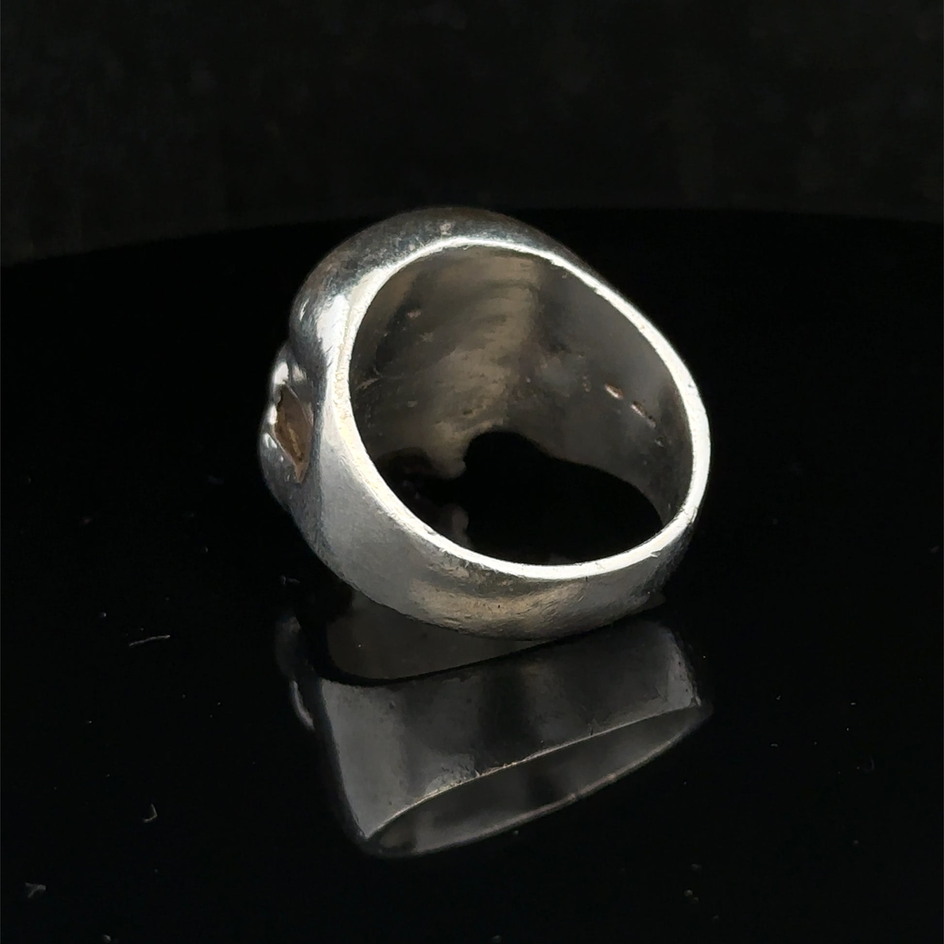 Silver skull ring by Reeves and Sons, size Z1, featuring a detailed skull design in polished metal.